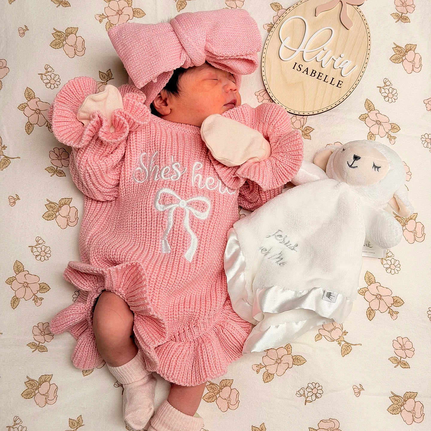 Olivia Isabelle joined the competition — help win amazing prizes! newborn, baby, pink_clothing, bow, sleeping, plush_toy, lamb, blanket, floral_pattern, wooden_sign, name_plaque, soft_toy, infant, cute, cozy, portrait, indoors, child, knitted, peaceful