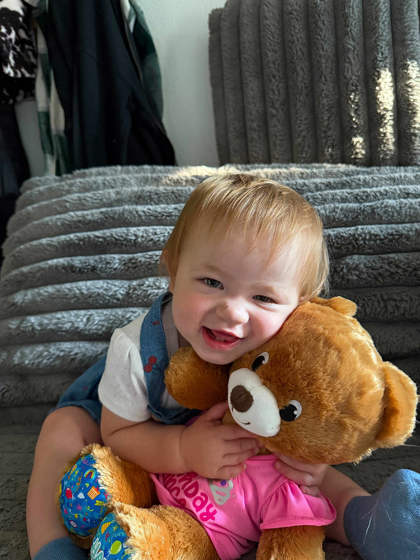 Evangeline joined the competition — help win amazing prizes! toddler, child, smiling, teddy_bear, plush_toy, couch, indoor, happy, cute, clothing, blue_eyes, light_hair, hugging, soft_toy, fabric, sitting, coats, background, home, portrait