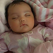 Star is registered to the contest to win money with this photo: baby, sleeping, onesie, pink, blanket, soft, cozy, infant, child, face, peaceful, closed_eyes, cute, young, resting, indoors, warm, comfort, portrait, toddler