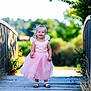 Emilie a rejoint le concours — aidez-le/la à gagner de superbes lots ! bridge, child, cute, daylight, dress, fashion, footwear, girl, greenery, happy, nature, outdoor, pink_dress, portrait, sandals, smiling, summer, sunlight, toddler, wooden_bridge