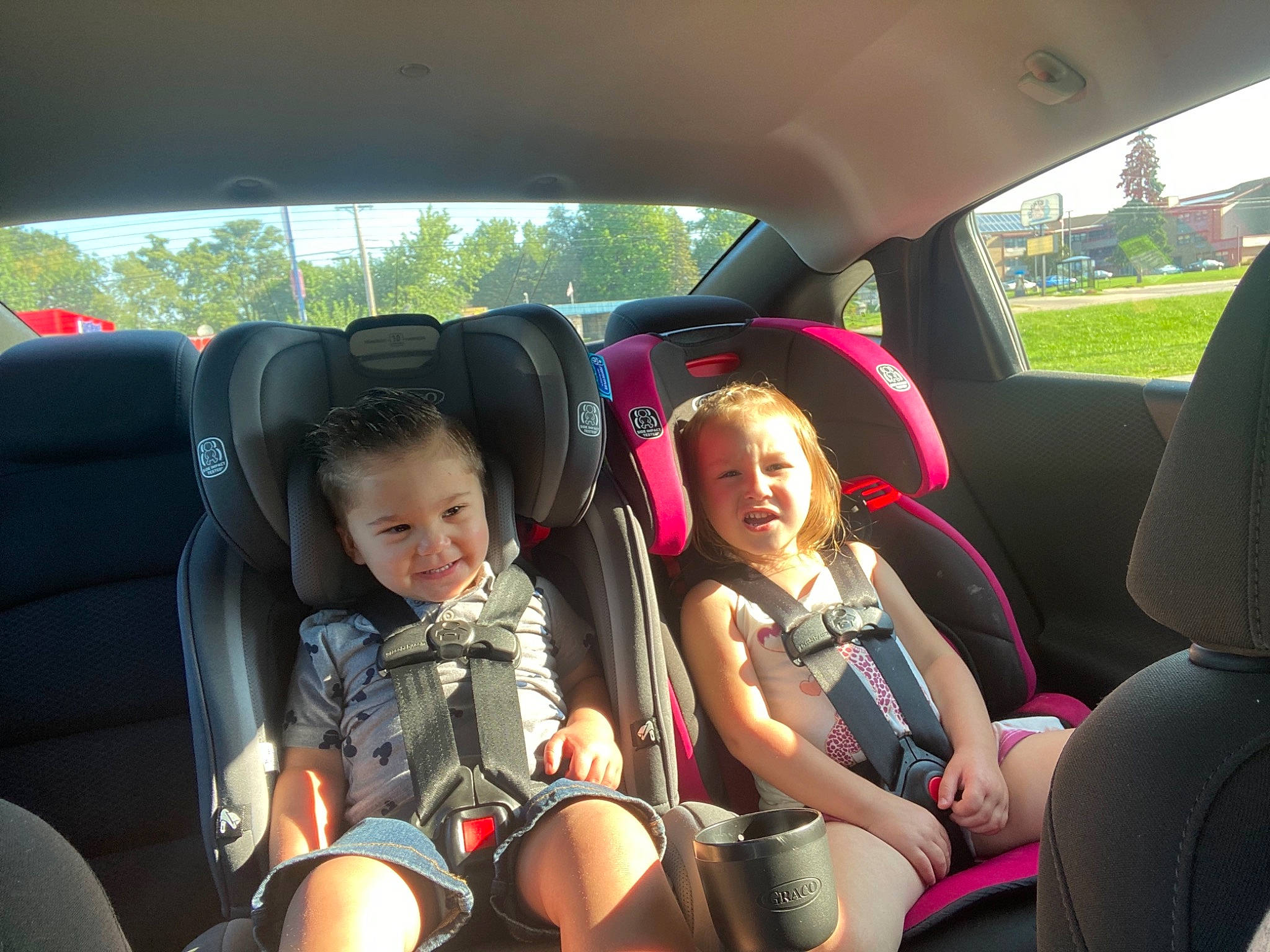 Elijah is registered to the contest to win money with this photo: auto_part, automotive_design, automotive_exterior, car, car_seat, car_seat_cover, comfort, head_restraint, joy, leisure, motor_vehicle, person, plant, seat_belt, shorts, smile, steering_part, steering_wheel, travel, vehicle