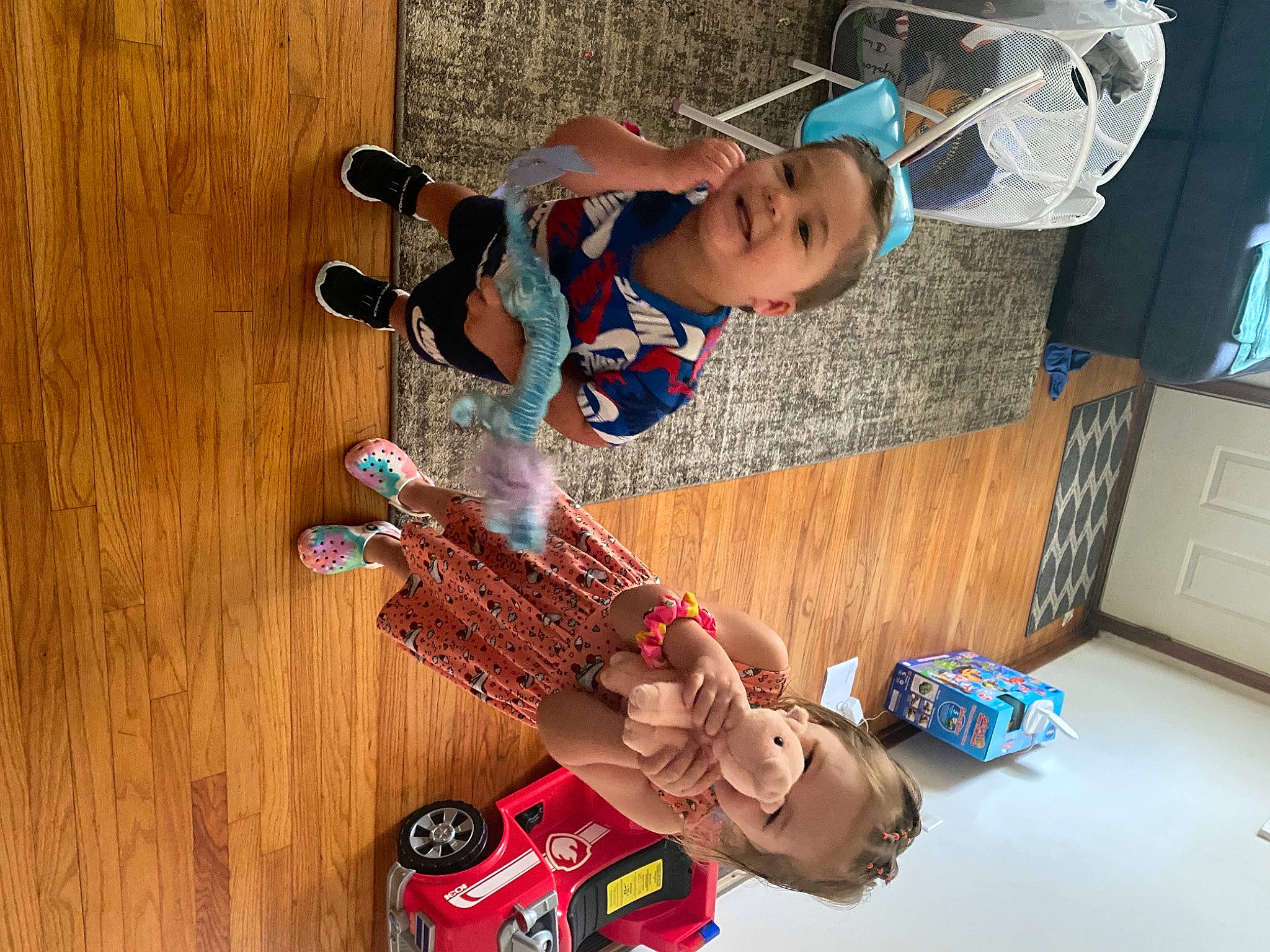 Elijah is registered to the contest to win money with this photo: arm, baby, baby_products, baby_toys, cabinetry, carmine, child, electric_blue, flooring, fun, hardwood, home_appliance, nail, person, personal_protective_equipment, play, room, toddler, toy, toy_vehicle