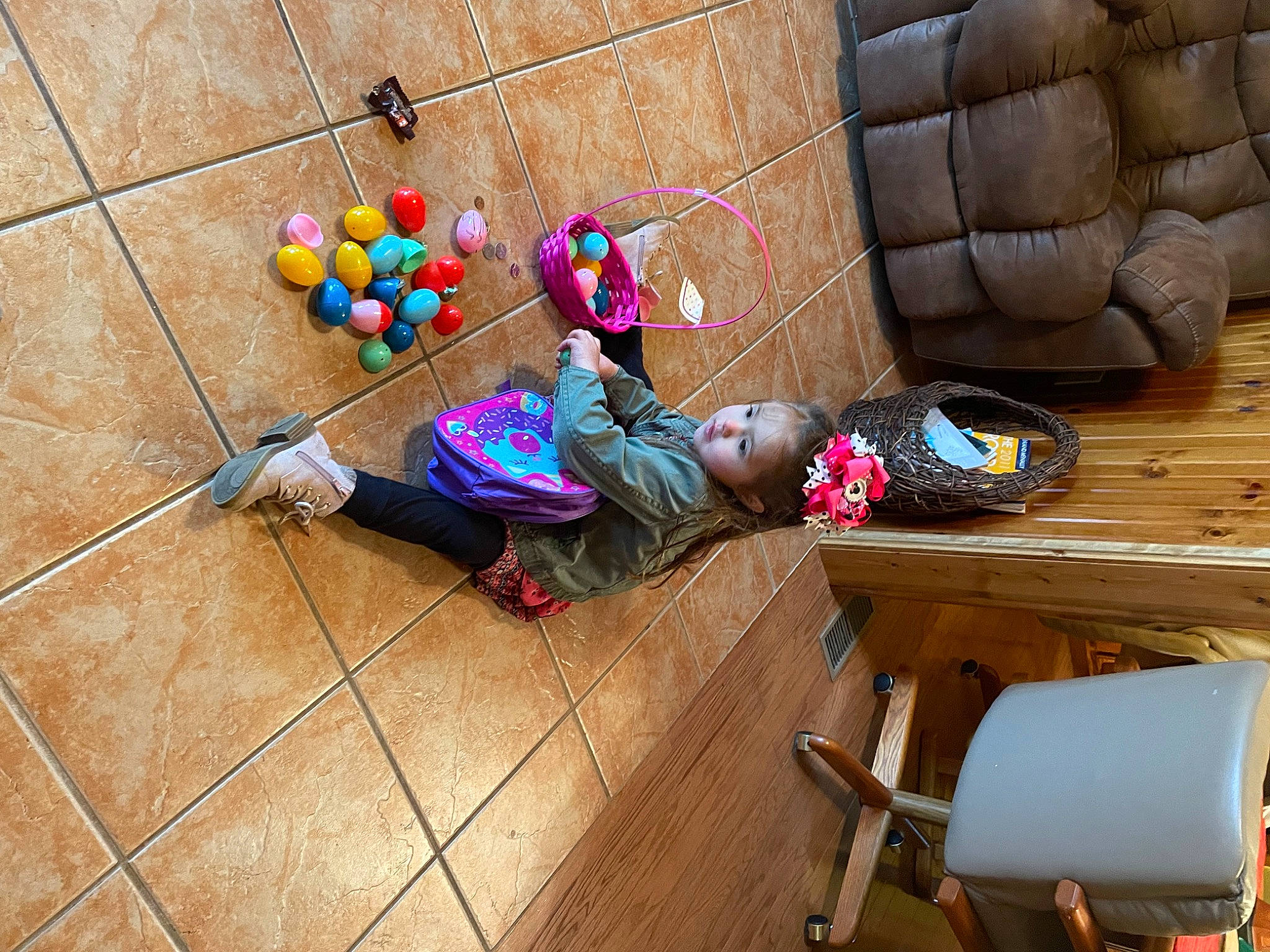 Lindsey is registered to the contest to win money with this photo: bag, child, couch, fashion_accessory, floor, flooring, hardwood, leisure, luggage_and_bags, pattern, person, play, room, shoe, sitting, stuffed_toy, toddler, toy, wood, wood_flooring