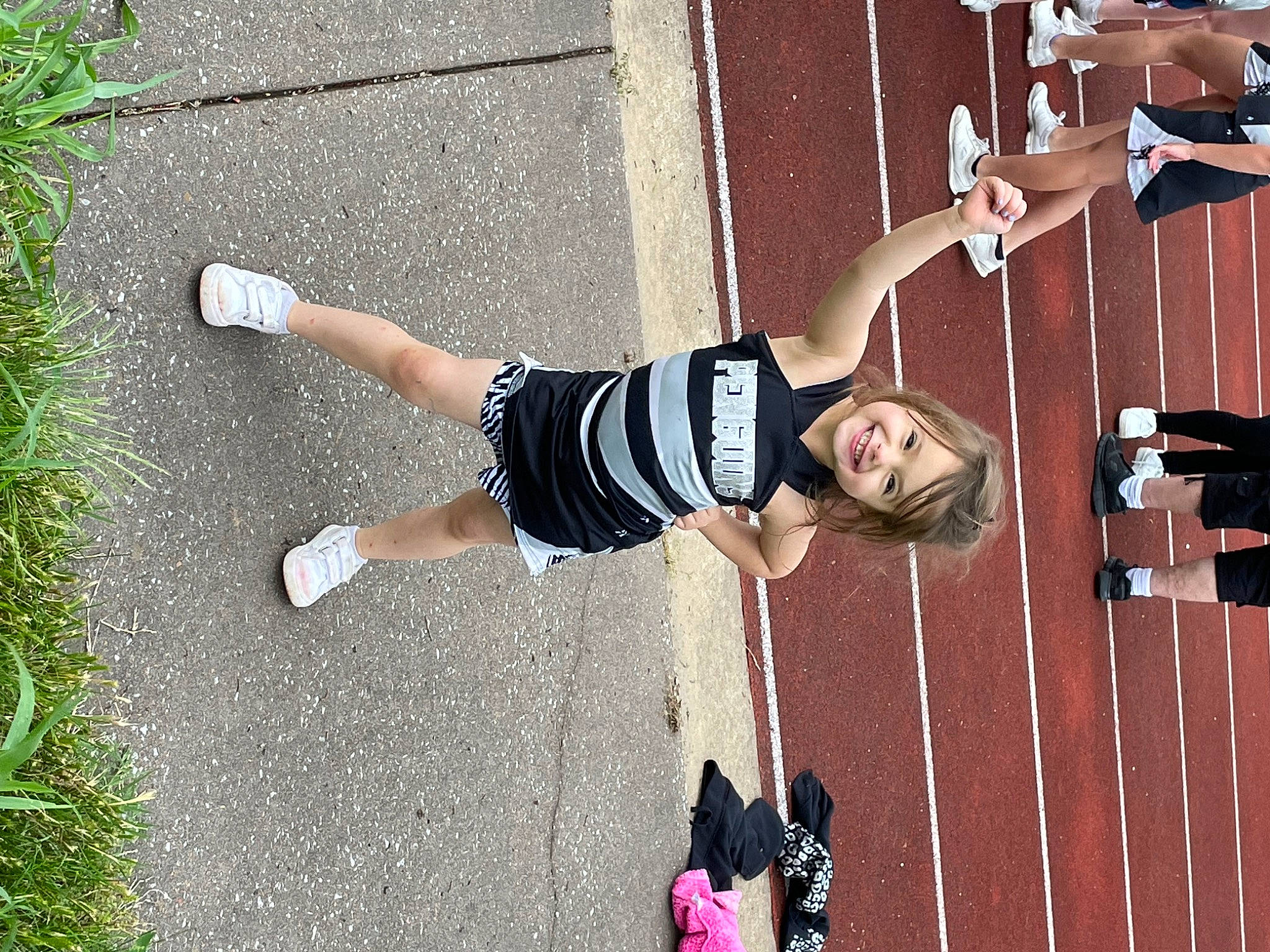 Lindsey is registered to the contest to win money with this photo: asphalt, elbow, entertainment, exercise, fun, human_leg, joy, knee, leg, person, physical_fitness, recreation, shadow, shoe, shorts, smile, sneakers, sports, sports_uniform, sportswear