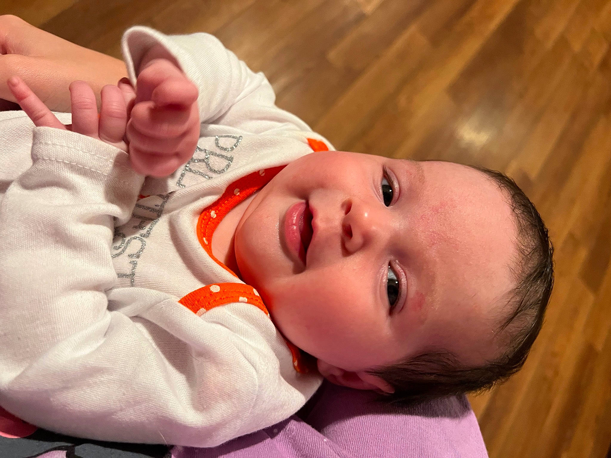 Everly is registered to the contest to win money with this photo: baby, baby_products, baby_toddler_clothing, cheek, child, comfort, eyelash, fur, gesture, happy, hardwood, lip, nail, nose, person, skin, sleeve, smile, thumb, toddler