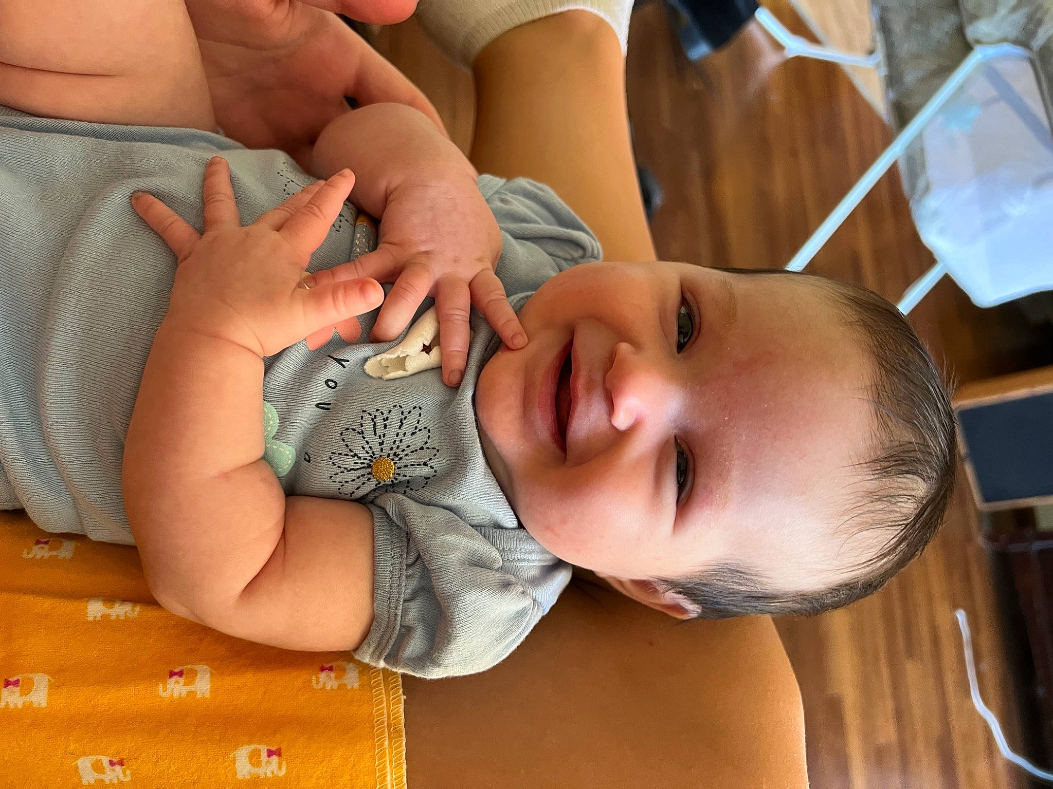 Everly is registered to the contest to win money with this photo: baby, baby_toddler_clothing, cheek, chest, child, comfort, eyelash, finger, fun, gesture, happy, mouth, nail, neck, person, skin, smile, thumb, toddler, wood