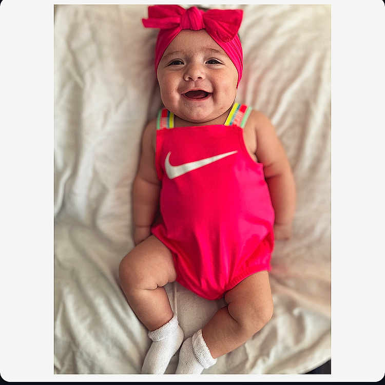 Sophia is registered to the contest to win money with this photo: baby, babylaughing, bodypart, bonnet, cap, clothing, dress, face, finger, hand, happy, hat, head, hood, laughing, newborn, person, photography, portrait, smile