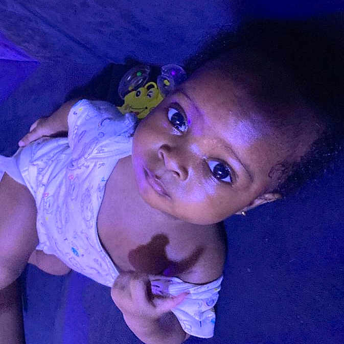 Aanuoluwapo is registered to the contest to win money with this photo: accessories, baby, bodypart, clothing, cream, dessert, dress, earring, face, finger, food, hand, happy, head, jewelry, person, photography, portrait, purple, smile