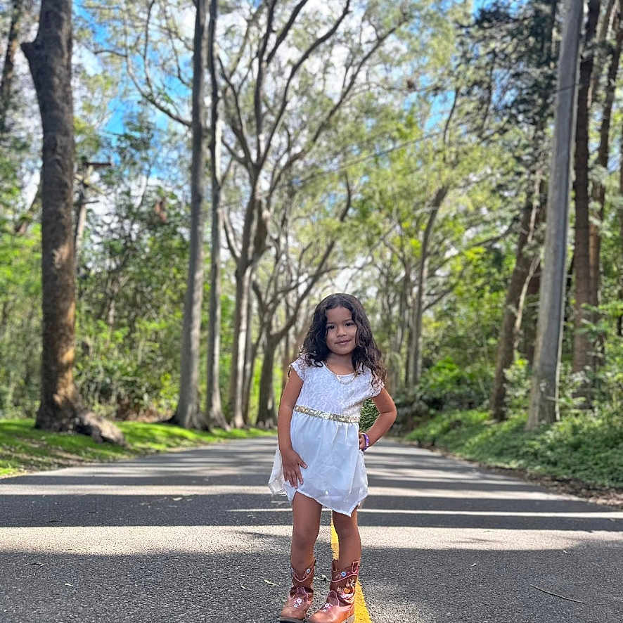 Toni joined the competition — help win amazing prizes! child, city, clothing, face, female, head, land, nature, outdoors, person, photography, plant, portrait, road, shorts, street, tree, urban, vegetation, woodland