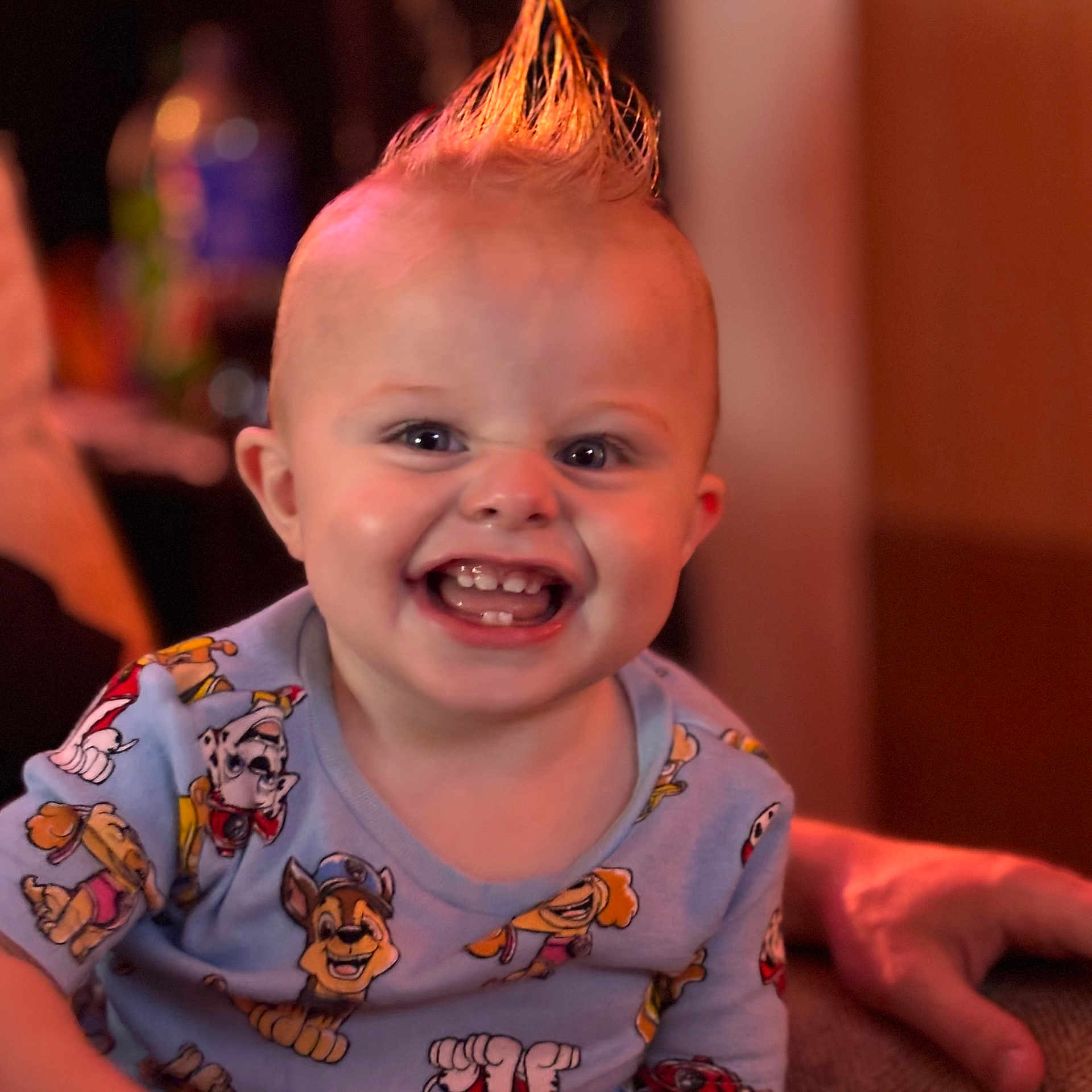Evan is registered to the contest to win money with this photo: baby, bright, cartoon_print, child, closeup, cute, expression, face, fun, hairstyle, hand, happy, indoor, mohawk, person, portrait, shirt, smiling, teeth, toddler