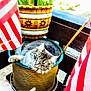 Luna joined the competition — help win amazing prizes! cat, flower_pot, american_flag, porch, outdoor, pet, feline, gray_cat, relaxed, cute, animal, plant, wooden_railing, green_eyes, striped, domestic_cat, sitting, resting, flagpole, decor