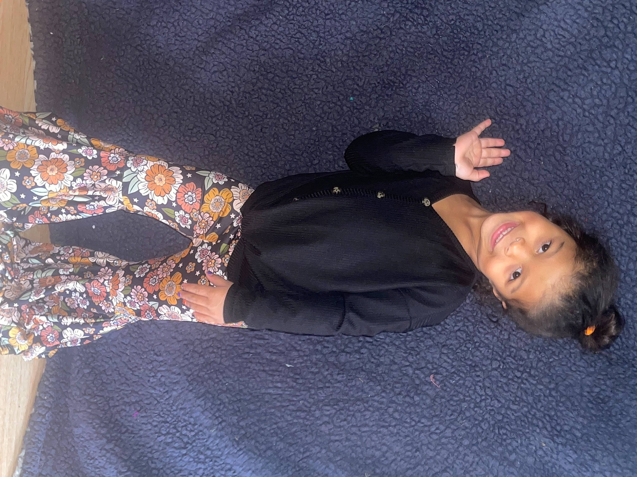 Juliahna is registered to the contest to win money with this photo: black_hair, child, comfort, couch, electric_blue, fashion_accessory, flooring, fun, fur, grey, human_body, human_leg, joy, knee, linens, pattern, person, room, sitting, sleeve