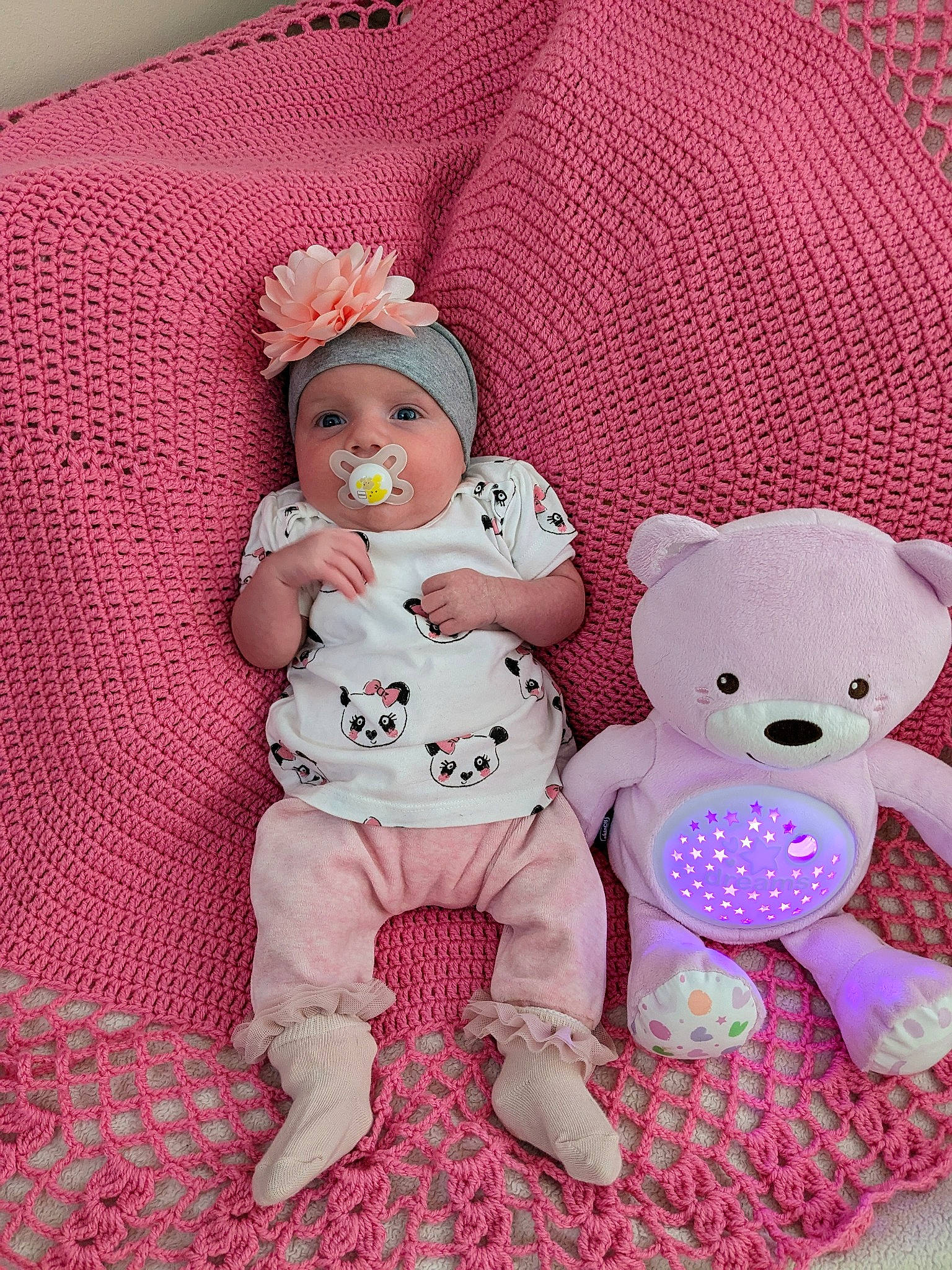 Amelia is registered to the contest to win money with this photo: baby, baby_sleeping, baby_toddler_clothing, cheek, child, comfort, doll, fashion_accessory, head, headwear, linens, magenta, pattern, person, pink, product, skin, sleeve, stuffed_toy, textile