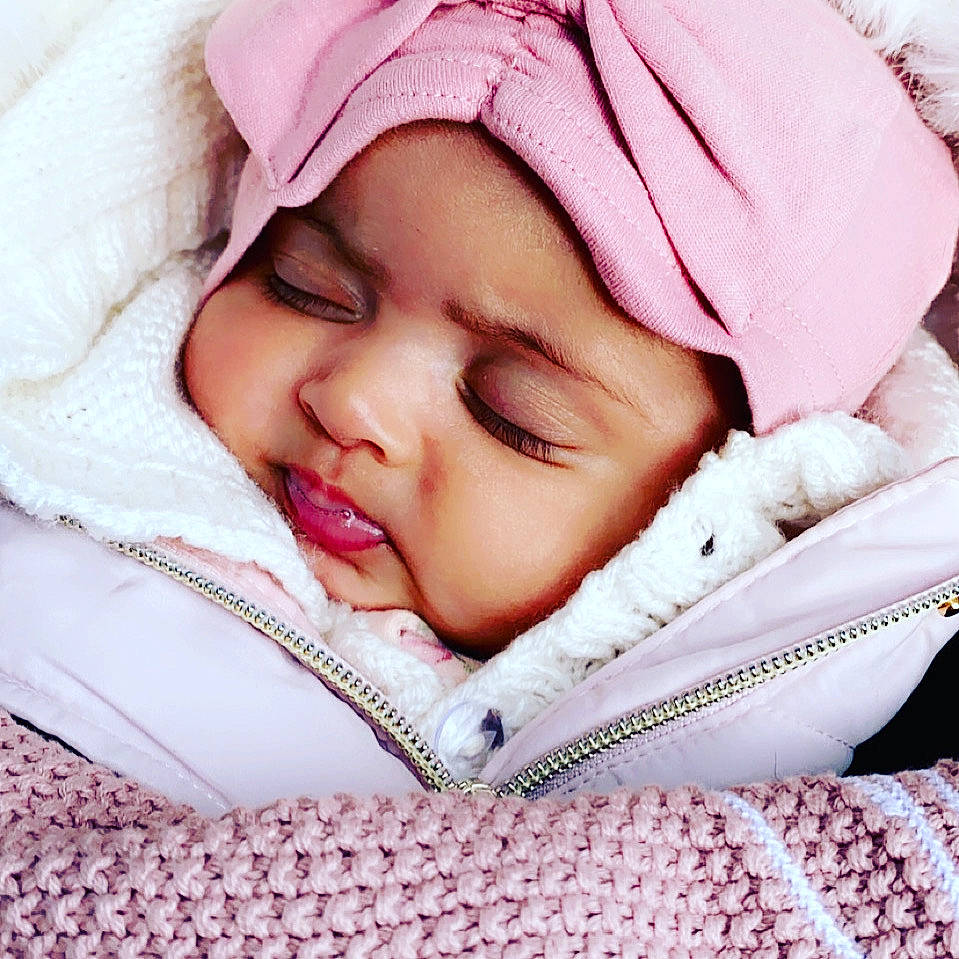 Adley is registered to the contest to win money with this photo: baby, baby_sleeping, baby_toddler_clothing, cap, cheek, comfort, eyelash, face, happy, headwear, linens, lip, magenta, mouth, nose, person, pink, skin, sleeve, smile