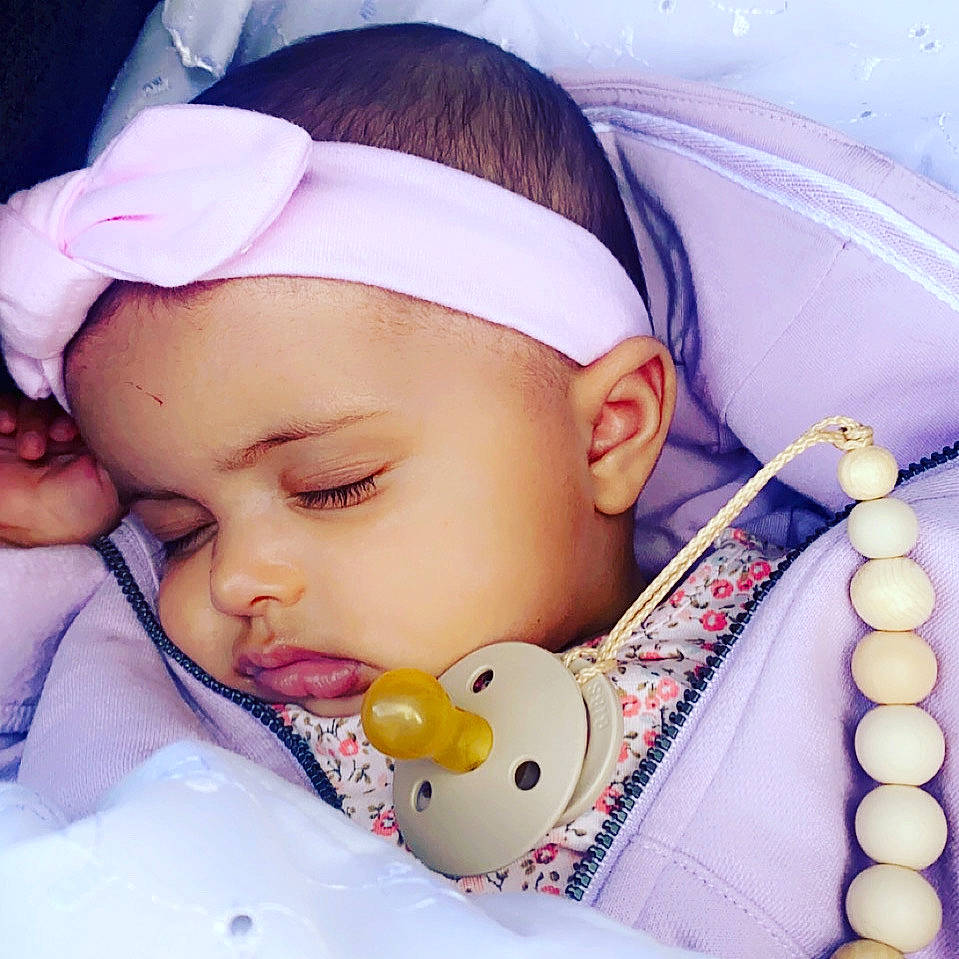 Adley is registered to the contest to win money with this photo: baby_sleeping, cheek, chin, comfort, eye, eyebrow, eyelash, facial_expression, hand, happy, head, headwear, human_body, lip, mouth, neck, nose, organ, person, product