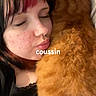 affection, black_clothing, cat, close_up, closed_eyes, comfort, cozy, cute, face, fur, hair, indoor, nose_ring, orange_cat, person, pet, red_hair_highlight, resting, snuggling, young_adult