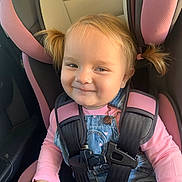 Lola is registered to the contest to win money with this photo: babytrend, blonde_hair, car_interior, car_seat, casual_wear, child, cute, daylight, denim_overalls, happy, infant, kid, pigtails, pink_clothing, portrait, safety_harness, seatbelt, smile, toddler, young_child