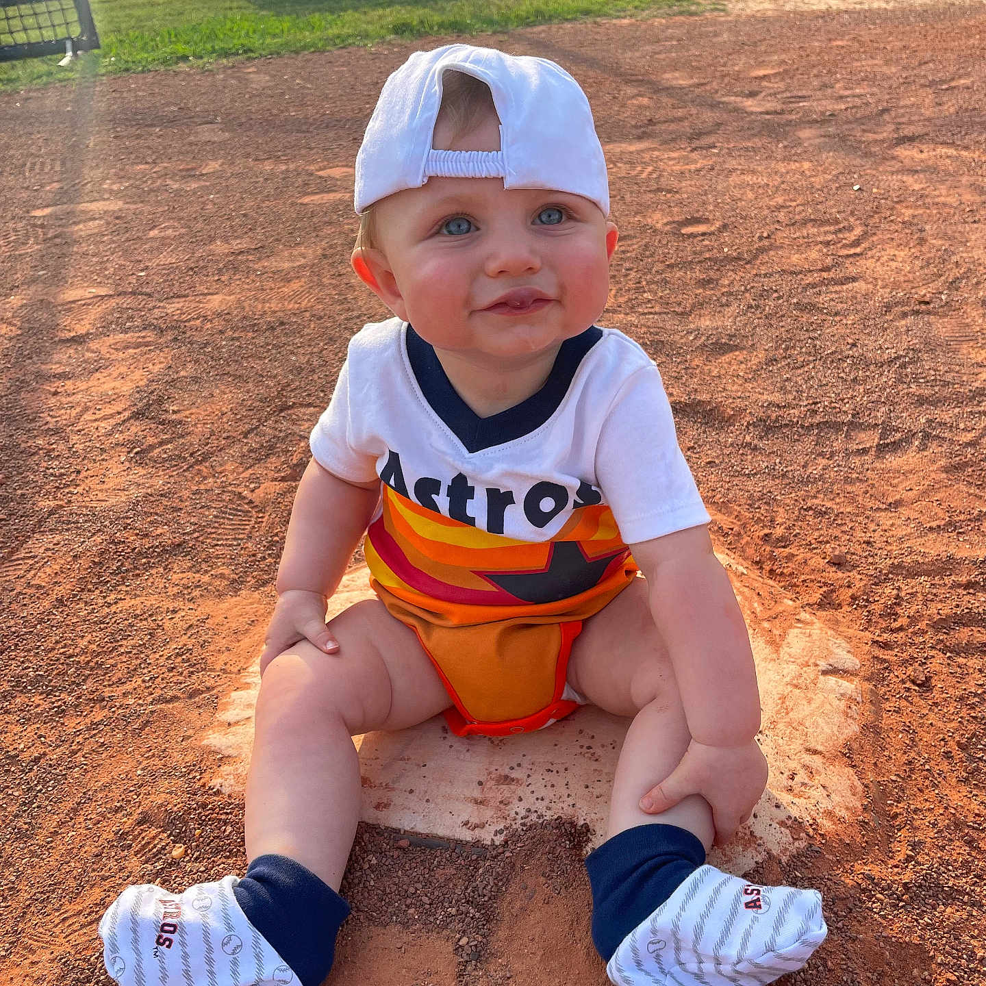 Brayden joined the competition — help win amazing prizes! ball, baseballcap, cap, clothing, face, football, grass, hat, head, nature, outdoors, park, people, person, photography, plant, portrait, sitting, soccer, soil