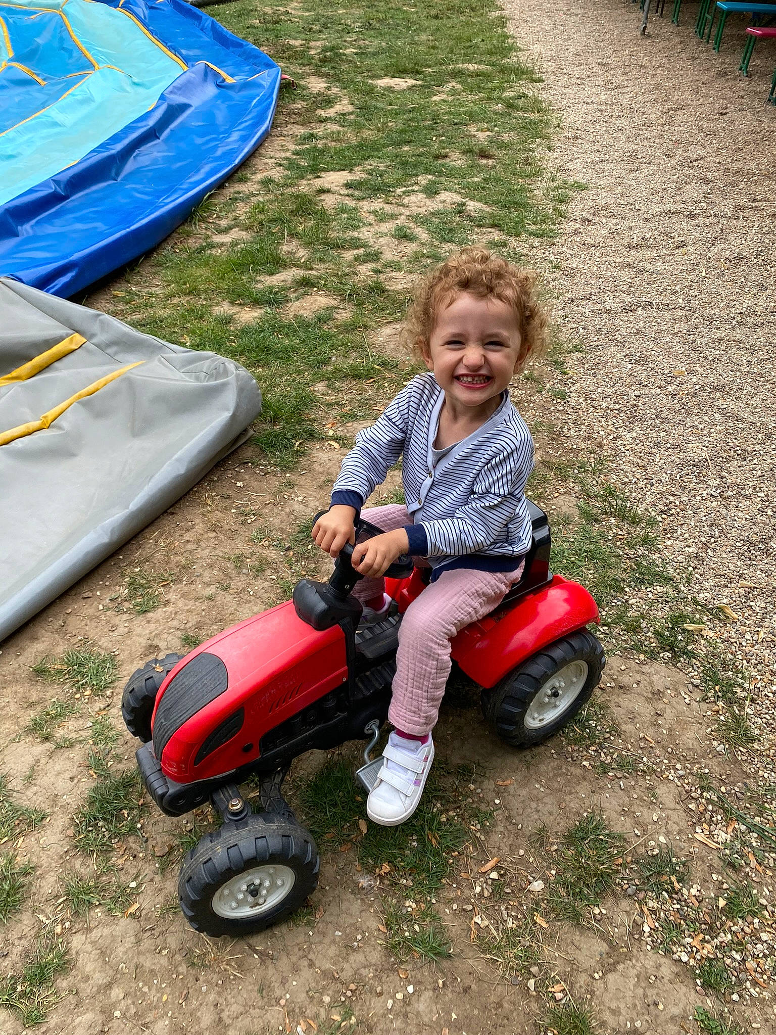 Amelia a rejoint le concours — aidez-le/la à gagner de superbes lots ! asphalt, automotive_tire, automotive_wheel_system, blue, child, fun, grass, joy, lawn, motor_vehicle, people_in_nature, person, public_space, recreation, riding_toy, rolling, smile, tire, toddler, toy