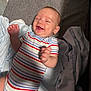 Houston is registered to the contest to win money with this photo: baby, blanket, child, comfort, cozy, cute, fabric, face, hands, happy, indoors, infant, joy, lying_down, newborn, portrait, skin, smiling, soft_surface, striped_onesie