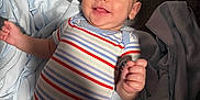 Houston joined the competition — help win amazing prizes! baby, bed, blanket, child, comfort, cute, fabric, face, hand, happy, head, indoors, infant, lying_down, onesie, portrait, skin, smiling, striped_clothing, young