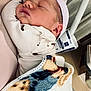 Houston is registered to the contest to win money with this photo: newborn, baby, sleeping, blanket, hat, person, hospital, bed, medical_equipment, closeup, infant, cozy, resting, indoor, soft, cute, swaddled, care, comfort, peaceful