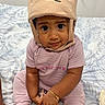 Ariana Castillo is registered to the contest to win money with this photo: baby, bear_hat, bed, bedding, bedroom, bracelet, child, cute, eyes, face, hat, indoors, infant, looking_at_camera, pants, phone, pink_clothing, portrait, sitting, striped_shirt