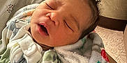 Daelynn joined the competition — help win amazing prizes! architecture, baby, blanket, building, childbirth, clothing, crying, face, head, hosiery, hospital, newborn, person, sad, sleeping, sock, yawning