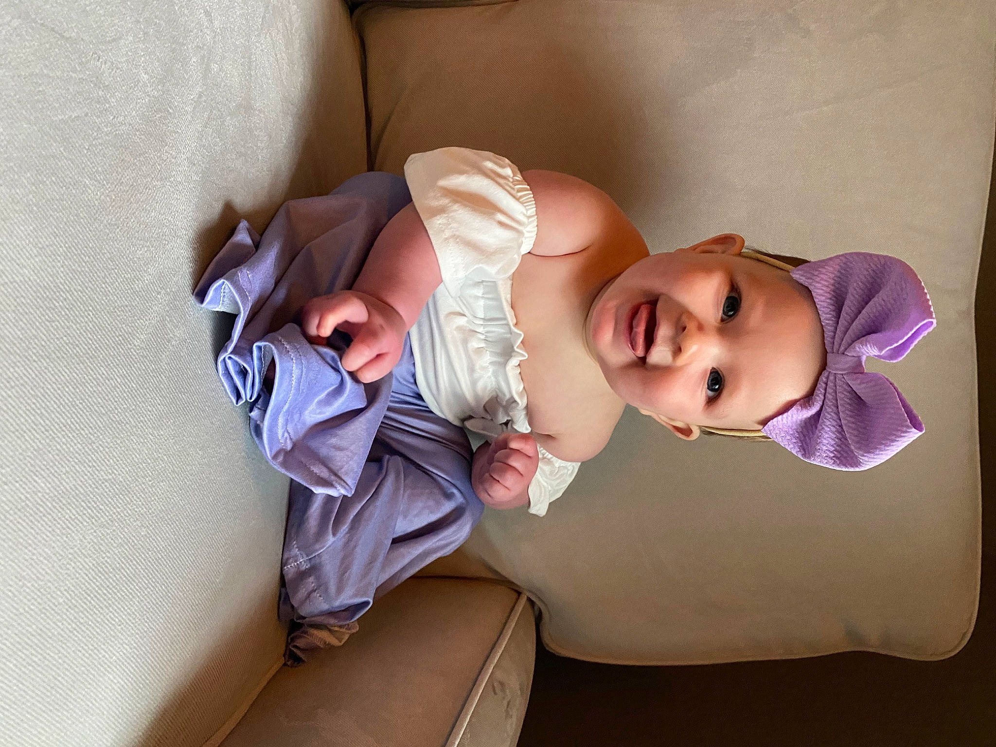 Lailah is registered to the contest to win money with this photo: baby, baby_toddler_clothing, child, comfort, eyewear, fashion_accessory, flash_photography, glasses, hat, headgear, headwear, human_leg, linens, person, room, shoulder, sitting, skin, smile, thigh
