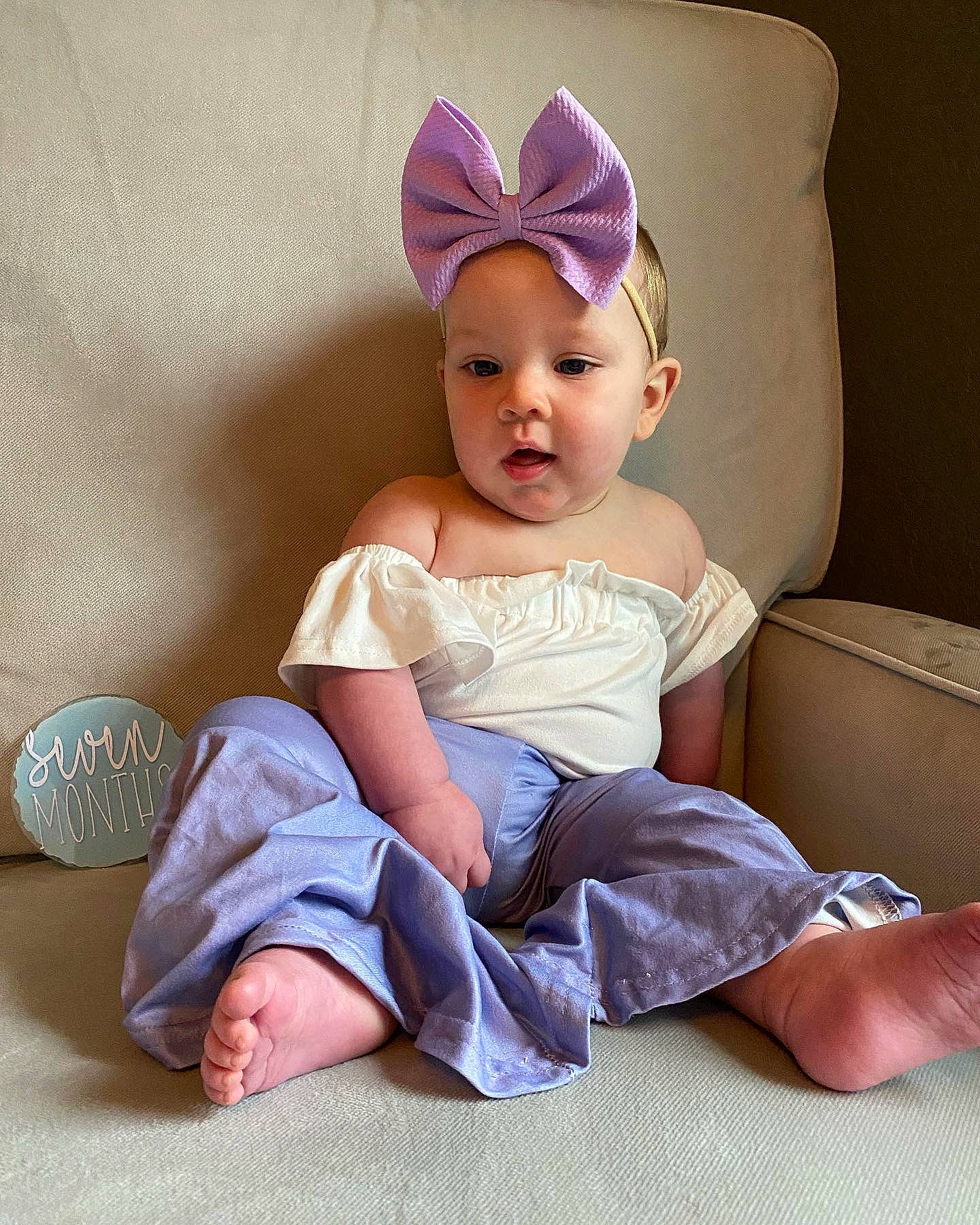 Lailah is registered to the contest to win money with this photo: baby, baby_toddler_clothing, cap, child, comfort, costume_hat, eye, face, hairstyle, happy, head, headband, headpiece, headwear, human_body, human_leg, person, pink, sitting, skin