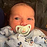 Arlo joined the competition — help win amazing prizes! baby, child, clothing, cute, expression, face, head, indoor, infant, mickey_mouse, newborn, onesie, pacifier, person, portrait, sitting, soft_lighting, warm_colors, winnie_the_pooh, wrapped