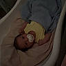 baby, pacifier, blanket, bathtub, infant, sleepwear, indoors, child, resting, yellow_clothing, blue_blanket, young_child, face, head, person, bedroom, dark, quiet, comfort, lying_down
