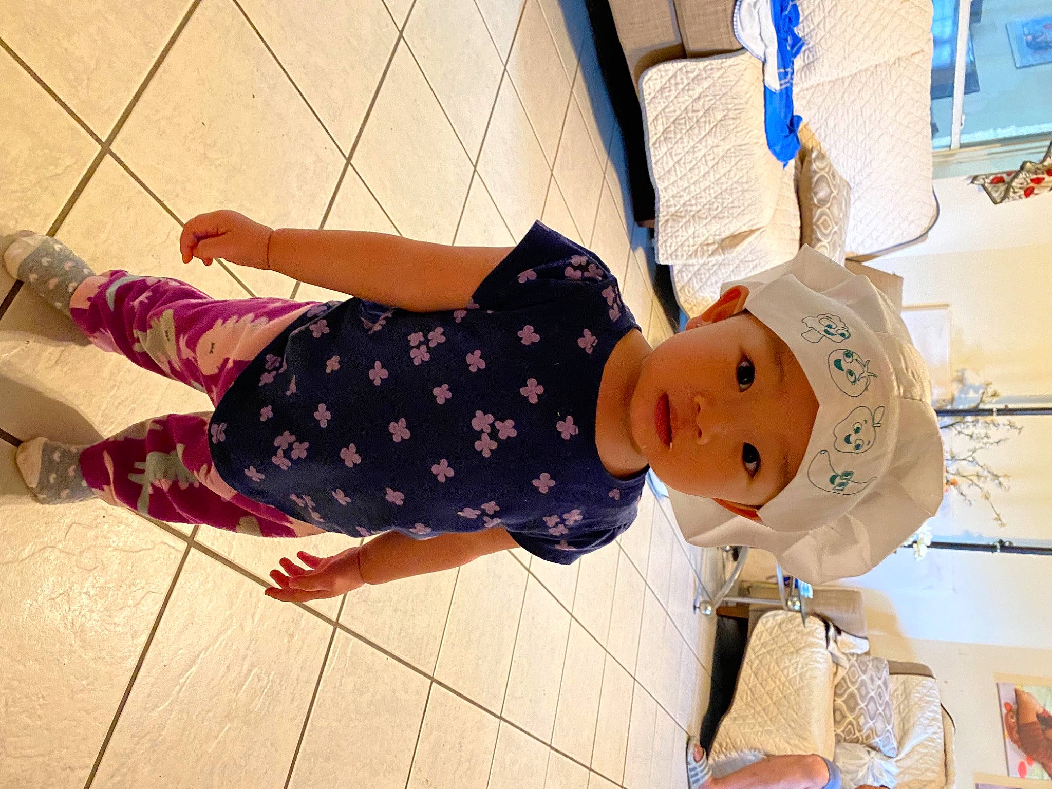 Katelynn is registered to the contest to win money with this photo: baby, baby_toddler_clothing, child, flooring, hat, headwear, human_leg, knee, pattern, person, plaid, room, sandal, sock, street_fashion, stuffed_toy, textile, thigh, toddler, toy