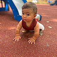 Kali participe au concours pour gagner de l'argent avec cette photo : baby, casual_clothing, child, crawling, curious, daylight, eyes, face, focus, hair, innocence, necklace, outdoor, person, playground, red_top, rubber_surface, slide, small_hands, young