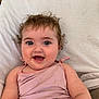baby, child, curly_hair, cute, expression, eyes, face, food_stains, happy, indoor, infant, messy, mouth, person, pillow, pink_clothing, portrait, skin, smile, tank_top