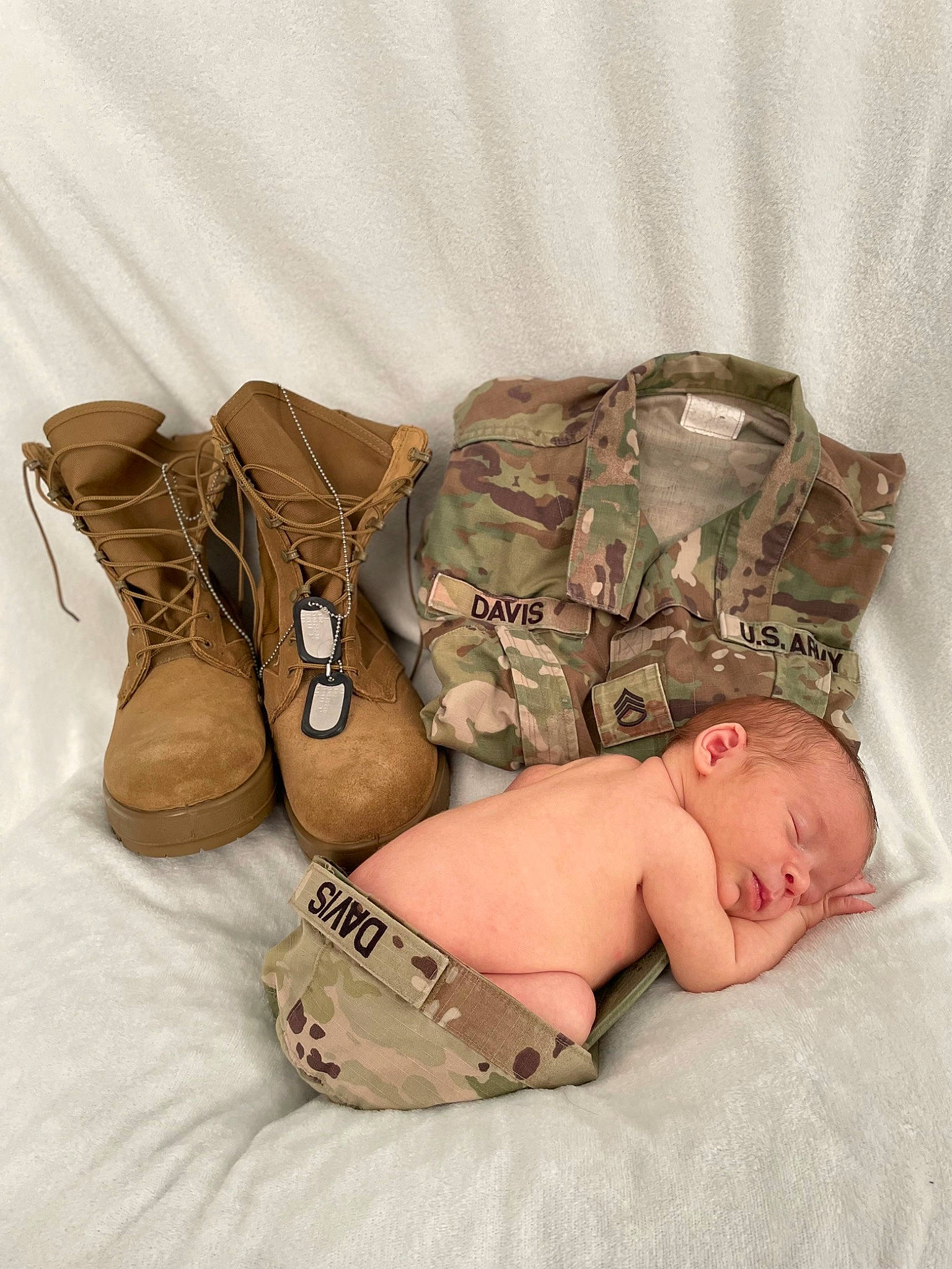 Tanner is registered to the contest to win money with this photo: abdomen, arm, baby, baby_products, baby_sleeping, baby_toddler_clothing, barechested, bedding, camouflage, chest, child, comfort, fashion_accessory, human_leg, military, military_camouflage, pattern, person, stomach, thigh