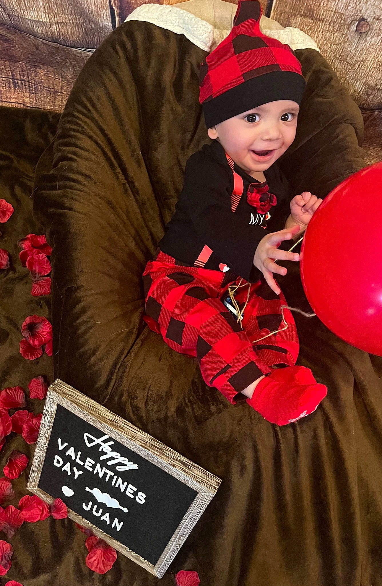 Juan joined the competition — help win amazing prizes! balloon, book, cap, carmine, child, costume, costume_hat, event, face, happy, headwear, holiday, magenta, party_supply, person, pink, publication, red, sitting, sleeve