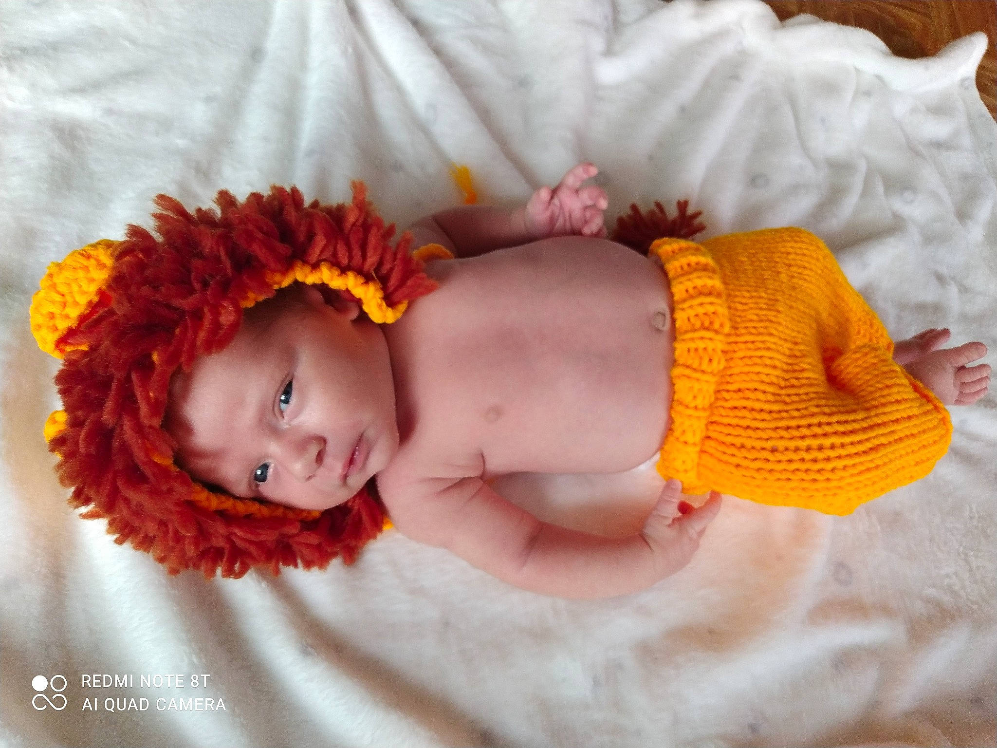 Nathan participe au concours pour gagner de l'argent avec cette photo : arm, baby, baby_products, baby_sleeping, baby_toddler_clothing, bedtime, cheek, child, comfort, happy, head, headband, headgear, iris, linens, orange, pattern, person, product, skin