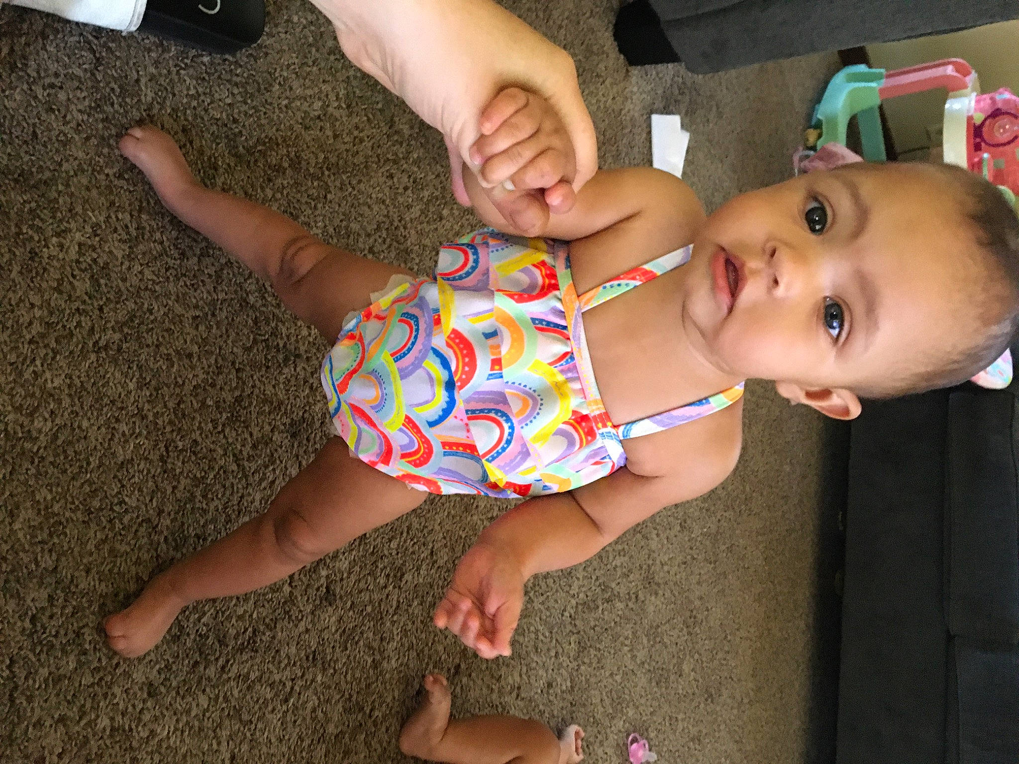 Heaven is registered to the contest to win money with this photo: baby, baby_toddler_clothing, child, finger, flooring, foot, fun, gesture, hand, happy, human_leg, joint, nail, pattern, person, pink, play, thigh, thumb, toddler