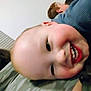 Ezekiel is registered to the contest to win money with this photo: baby, child, smile, face, closeup, camo, camo_clothing, person, indoor, happy, cheerful, young, head, skin, human, infant, sibling, blur, background, candid