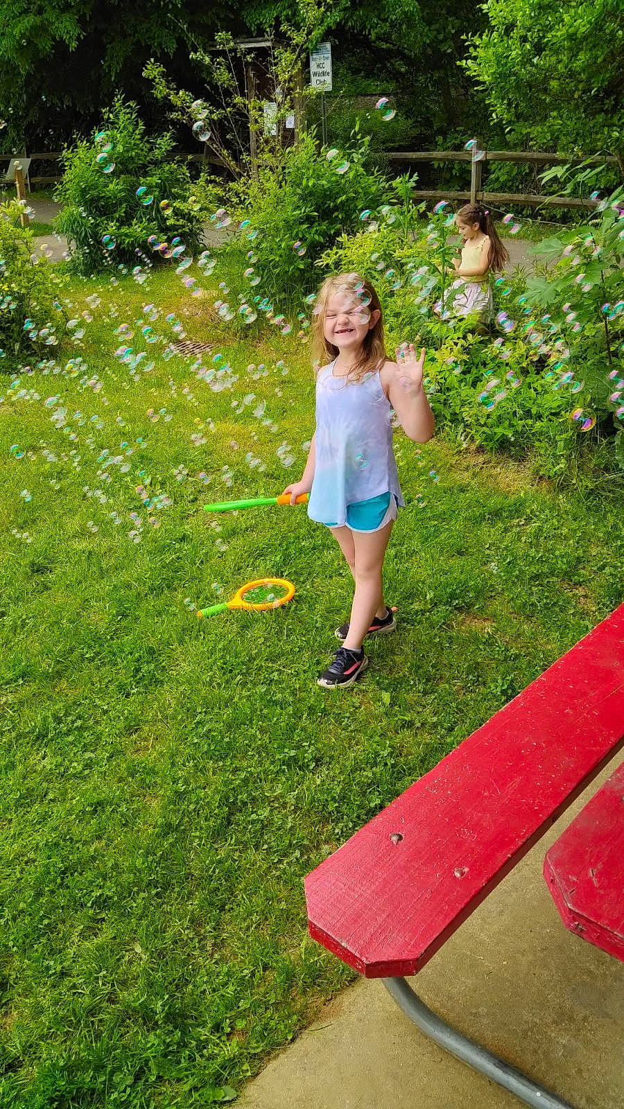 Briley is registered to the contest to win money with this photo: botany, flower, grass, grass_family, grassland, groundcover, happy, joy, landscape, lawn, leisure, meadow, outdoor_recreation, people_in_nature, person, plant, recreation, shorts, shrub, summer