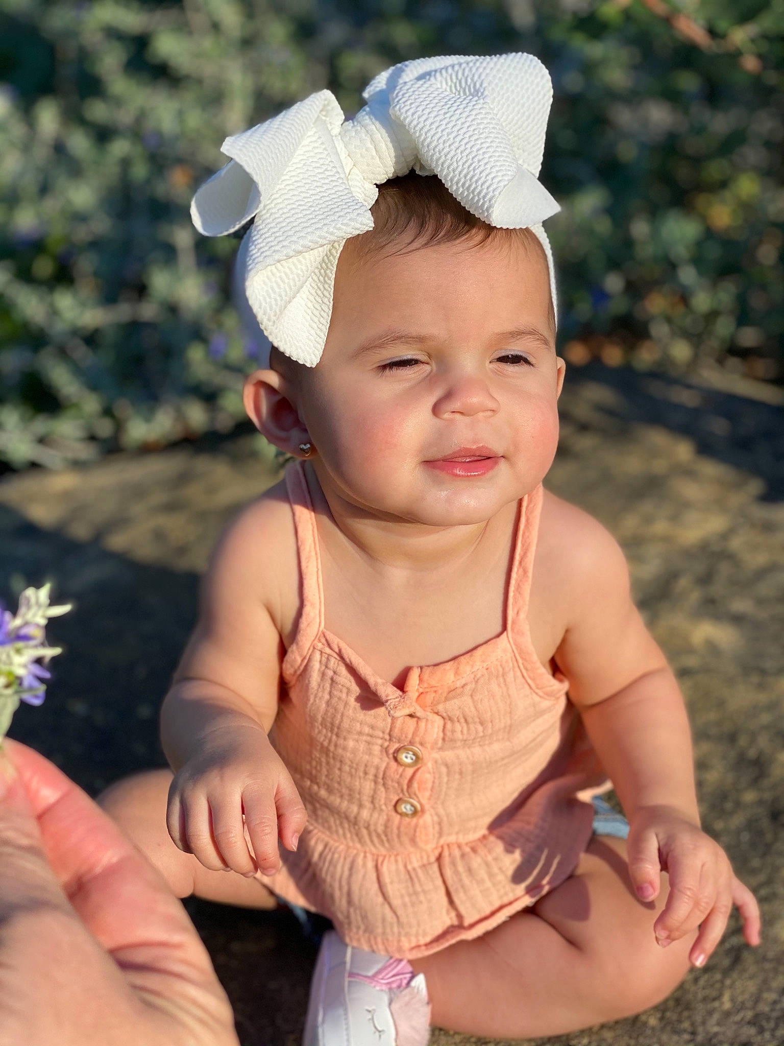 Jessica is registered to the contest to win money with this photo: arm, baby, baby_toddler_clothing, beauty, cap, child, finger, grass, hand, happy, headband, headpiece, pattern, person, pink, plant, skin, sleeve, smile, summer