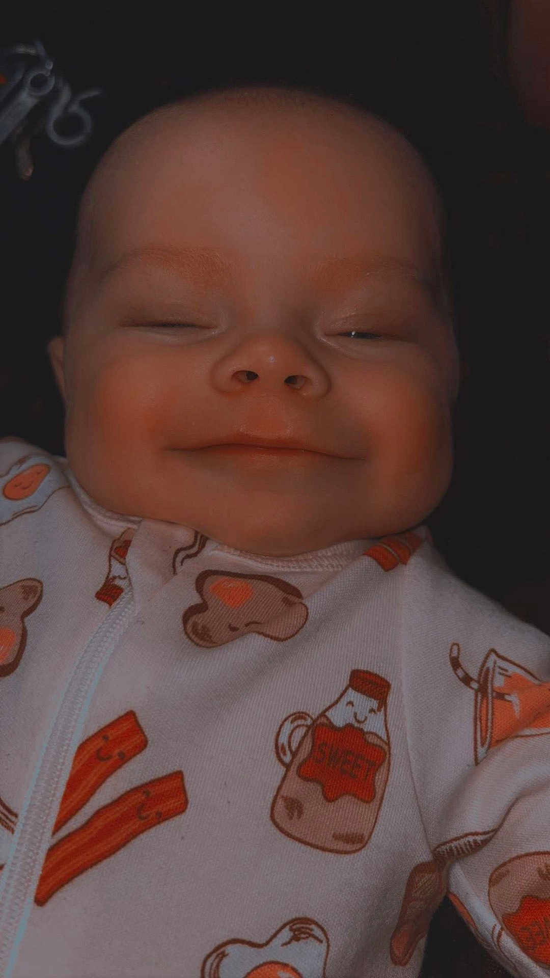 Gracen joined the competition — help win amazing prizes! baby, child, face, smile, sleepy, onesie, clothing, cute, infant, portrait, happy, closeup, soft_lighting, patterned_clothes, indoors, head, skin, expression, young, cozy
