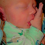 Cashton is registered to the contest to win money with this photo: baby, newborn, sleeping, thumb_sucking, onesie, dinosaur_pattern, infant, closeup, child, cute, peaceful, hand, face, skin, blanket, rest, young, portrait, comfortable, indoors