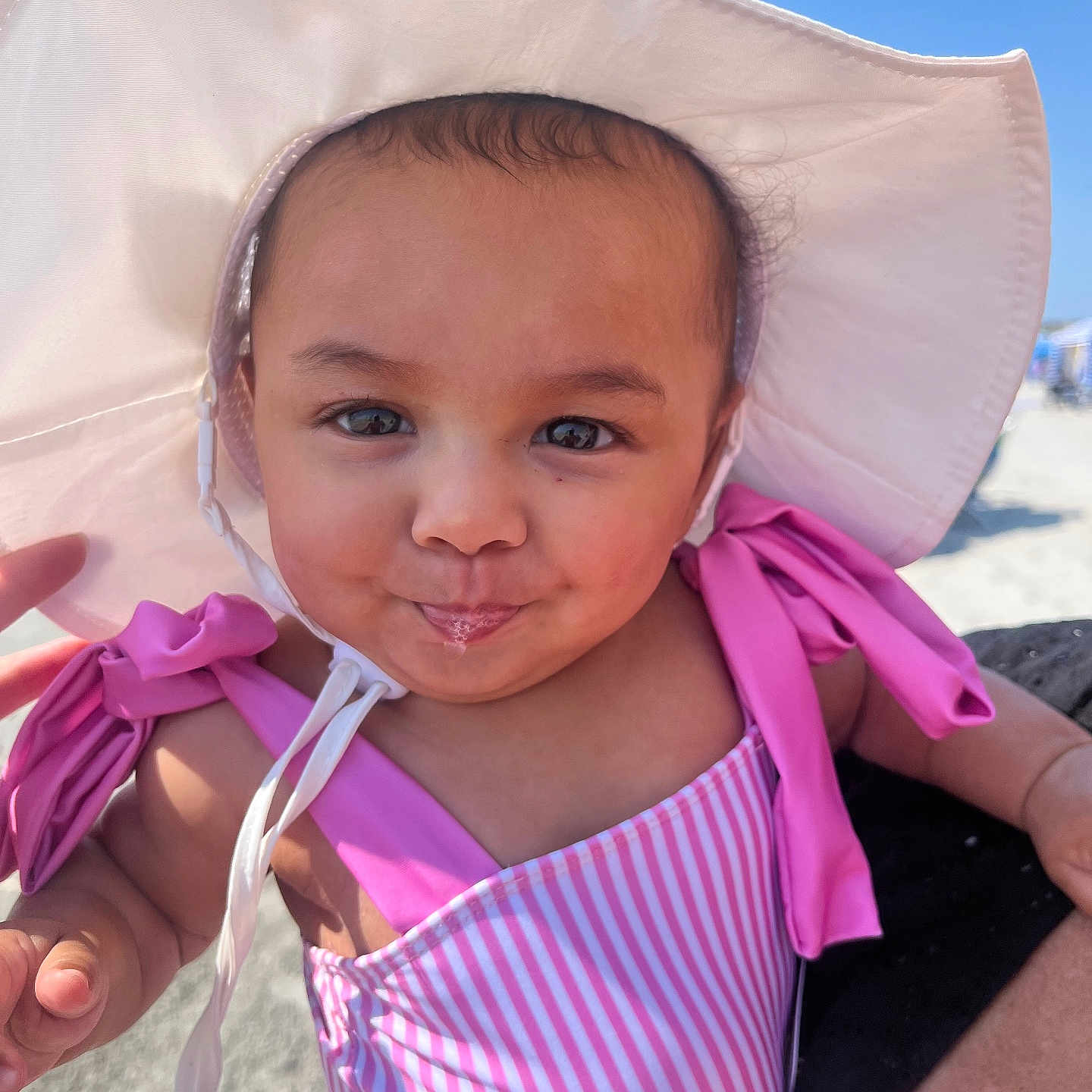 Kehlani Rodriguez joined the competition — help win amazing prizes! baby, beach, child, cute, drool, face, happy, holiday, infant, outdoor, person, pink_swimsuit, playful, portrait, sky, smile, summer, sunhat, sunshine, vacation