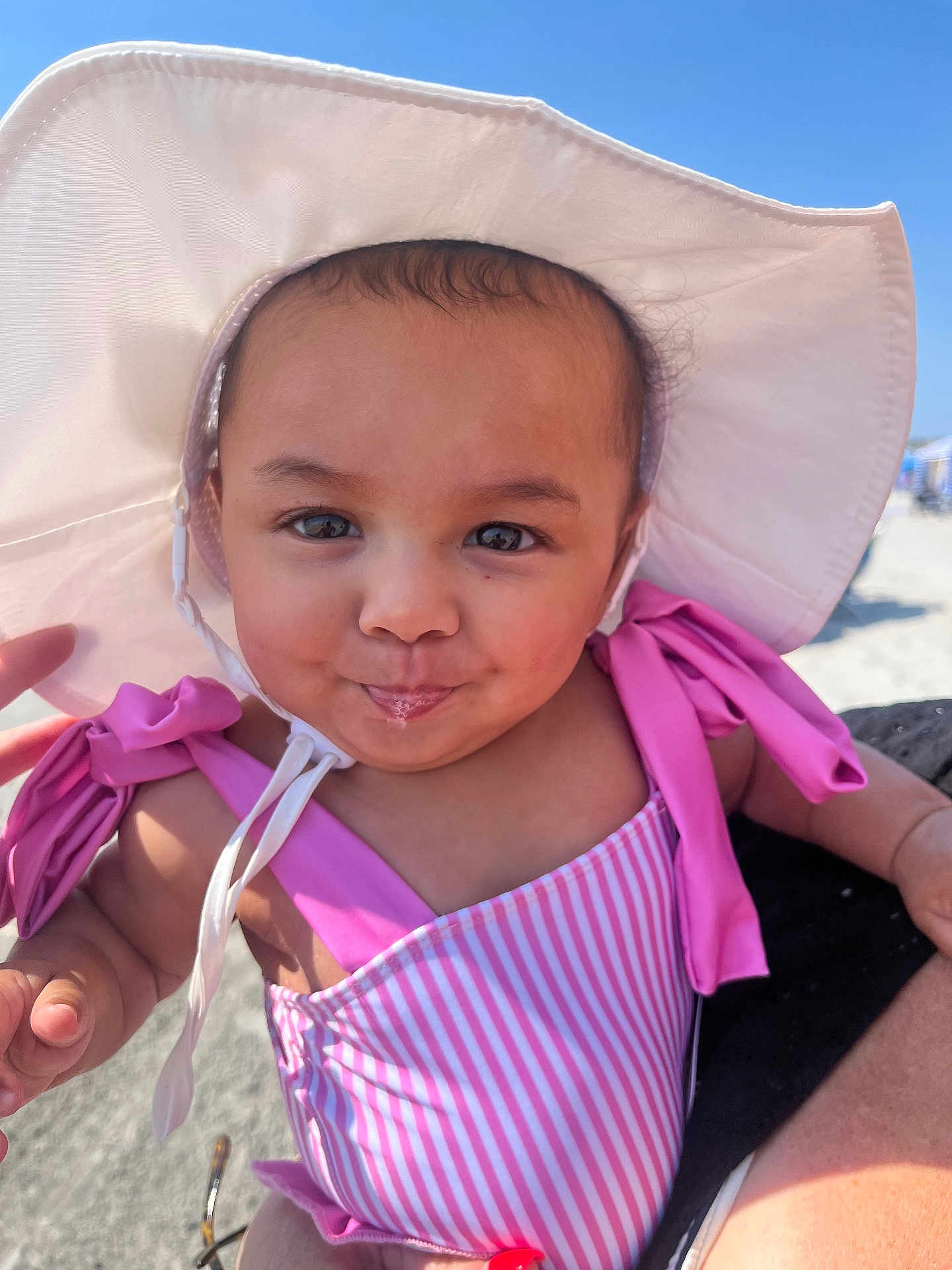 Kehlani Rodriguez joined the competition — help win amazing prizes! baby, child, sunhat, pink_swimsuit, drool, face, outdoor, beach, sky, summer, sunshine, portrait, cute, smile, infant, happy, person, vacation, holiday, playful