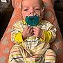 Holden joined the competition — help win amazing prizes! baby, infant, pacifier, striped_clothing, blanket, heart_pattern, medical_tube, lying_down, hands, fists, face, head, person, indoors, cute, newborn, sleepwear, comfort, soft, resting