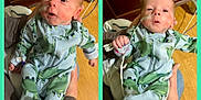 Holden is registered to the contest to win money with this photo: baby, infant, child, dinosaur_pajamas, nasal_tube, hands, wooden_cabinet, floor, indoor, person, clothing, cute, newborn, lying, bed, hospital, medical_tube, pajamas, portrait, holding