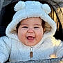 baby, smiling, hoodie, white_clothing, baby_clothing, happy, face, child, infant, stroller, cute, outdoor, warm_clothing, portrait, baby_face, baby_smile, cozy, soft_texture, baby_boy, baby_girl