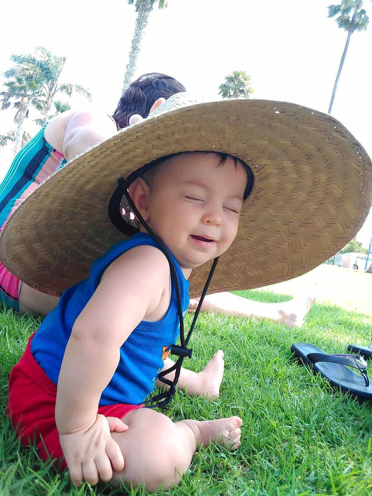 Isaiah is registered to the contest to win money with this photo: baby_toddler_clothing, cap, cowboy_hat, fedora, fun, grass, grassland, happy, hat, headwear, leisure, people_in_nature, person, plant, recreation, sky, smile, sombrero, summer, sun_hat